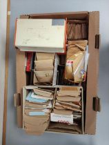 Box containing a large quantity of mixed World postage stamps contained within envelopes.