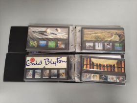 Two albums of c1990s-2000s British mint presentation packs postage stamp sets comprising of 46 first