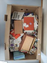 Box containing a large quantity of mixed World postage stamps.