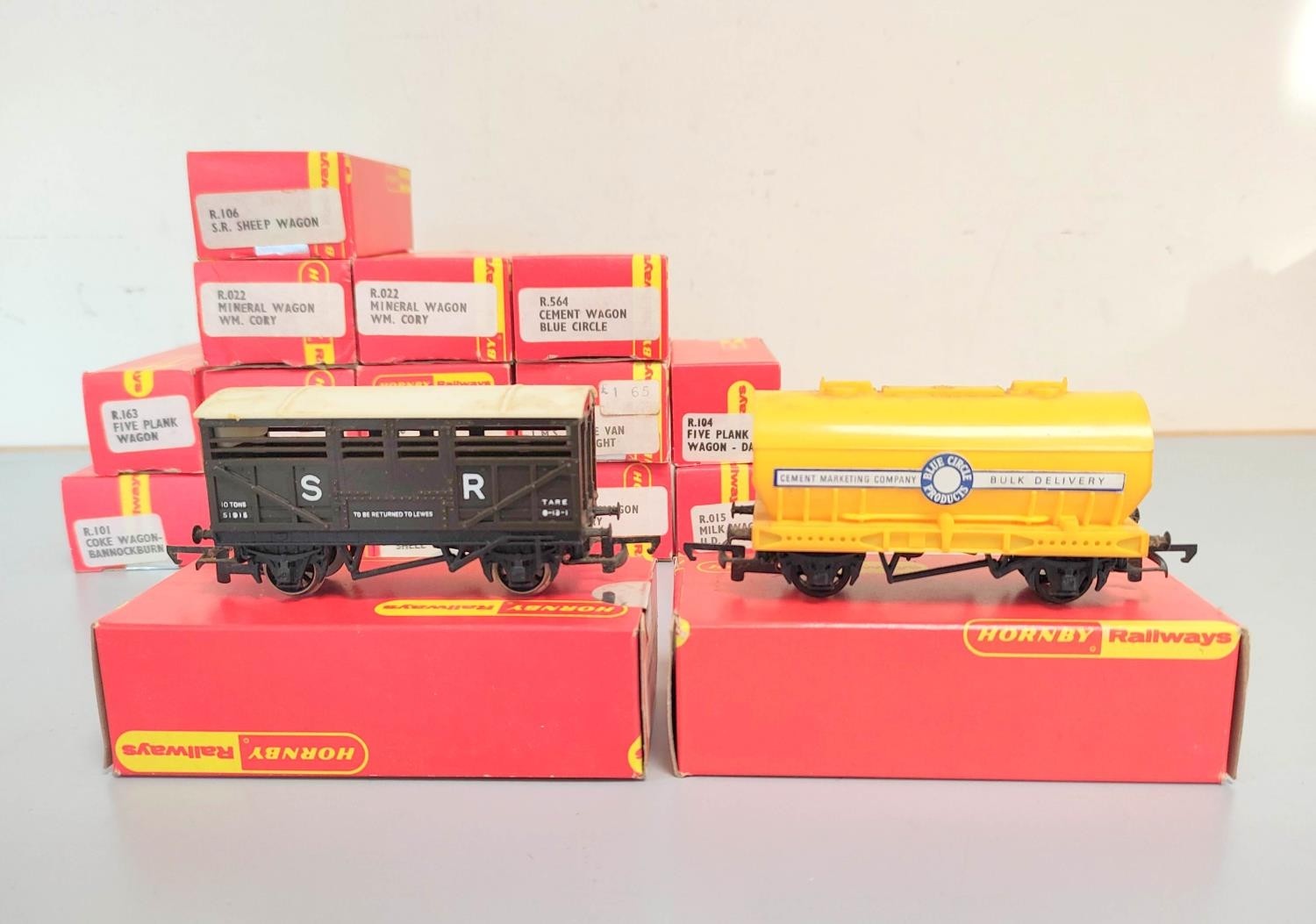 Hornby Railways. Sixteen boxed rolling stock goods vans and plank wagons to include Blue Circle