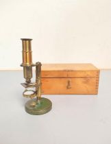 A miniature brass compendium microscope in original wooden case, height 16.5cm