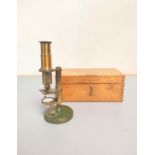 A miniature brass compendium microscope in original wooden case, height 16.5cm