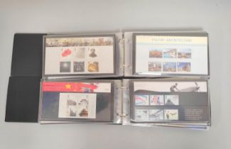 Two albums of c2000s British mint presentation packs postage stamp sets comprising of 215 first