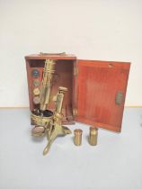 An unattributed mid Victorian monocular petrological microscope of gilt brass construction,