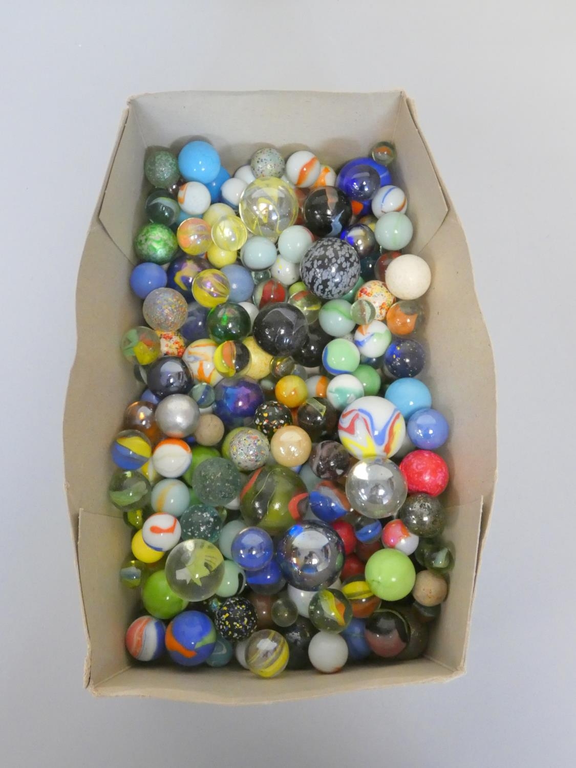 A large collection of vintage marbles to include Jacks and hand blown examples.