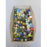 A large collection of vintage marbles to include Jacks and hand blown examples.