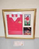 George Best. A framed signed Manchester United retro-style football shirt, signed above the club