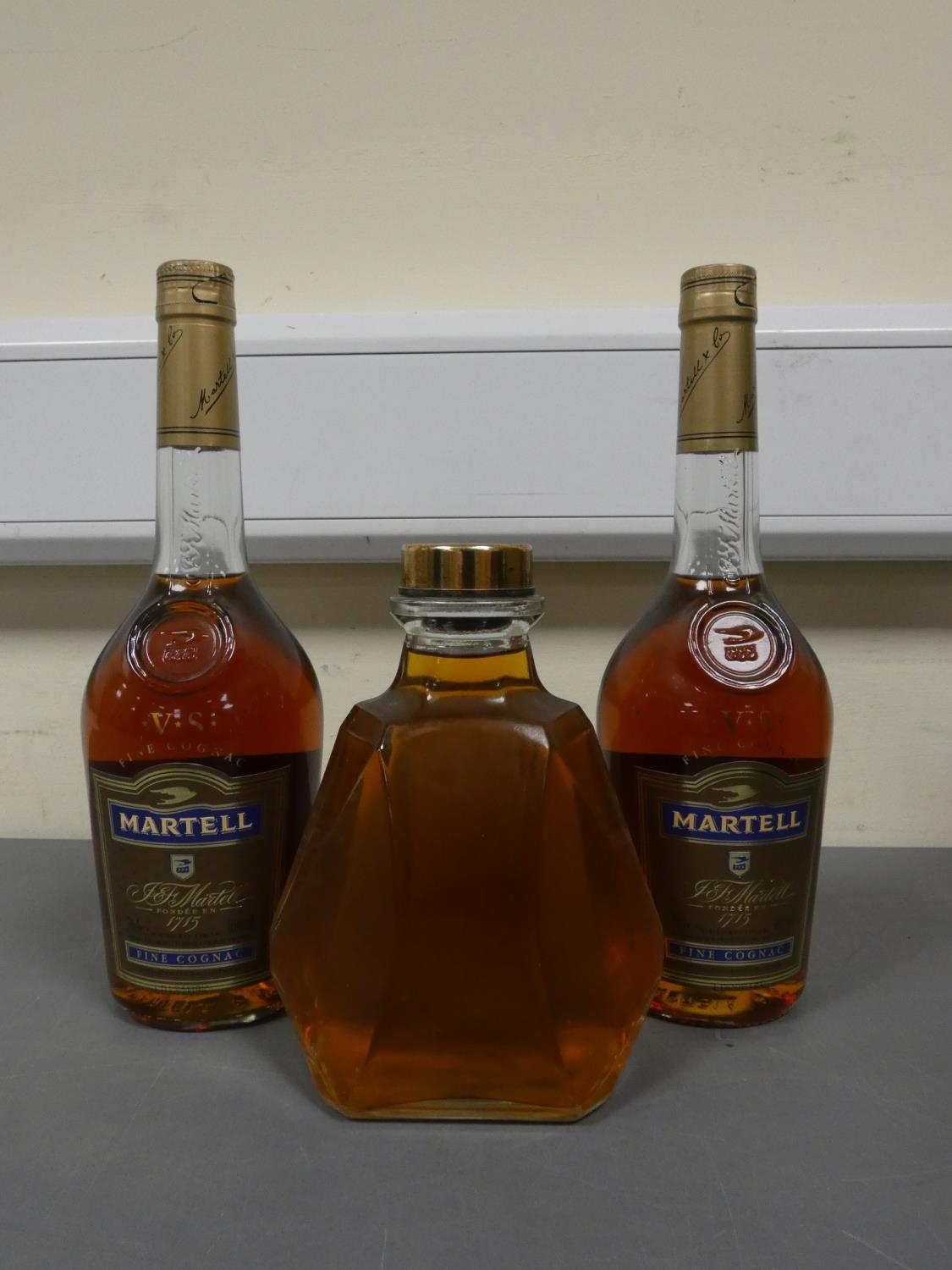 Two bottles of Martell V.S fine cognac, 70cl, 40% vol, with a glass decanter containing amber