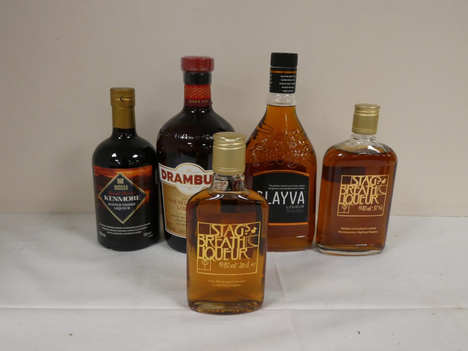 Five bottles of whisky liqueur to include DRAMBUIE 40% abv. 1litre, GLAYVA 35% abv. 70cl, KENMORE