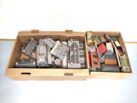 Two boxes of model railway buildings and track components to include a church, station building,