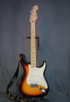 Fender Stratocaster six string electric guitar with Fender strap in hard fitted case, serial