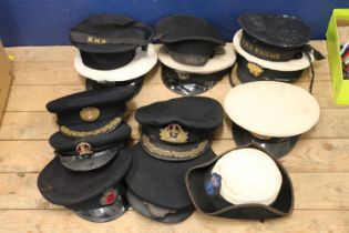 Five British Royal Navy black cloth peaked caps, one by Gieves Ltd, two sailors caps one with HMS