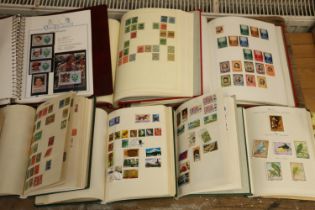 World stamp collection held across thirteen folders and albums, mostly 20th century used stamps.