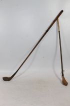 Antique hickory shafted golf club wood, the head stamped 'SEARLE', and a spoon type putter. (2)