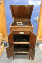 Fitonal antique record player cabinet and a collection of antique records.