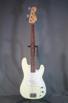 Artisan four string bass guitar with cream and white body in soft case.