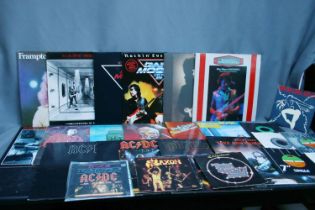 Record case containing a mix of artist to include Gary Moore, AC/DC, Thin Lizzy, Japanese AC/DC