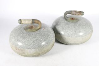 Pair of polished granite curling stones, early 20th century, with shaped wooden handles on metal