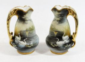 Pair of Noritake porcelain ewers, the shaped tapering bodies matte decorated with swans on a moonlit