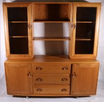 Ercol Windsor light elm modular sideboard/display cabinet, c1960s, of two glazed side cupboards with