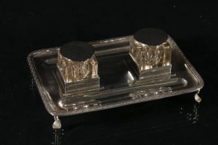 George V silver desk ink stand, the rectangular base with rounded corners, bead and shell embossed
