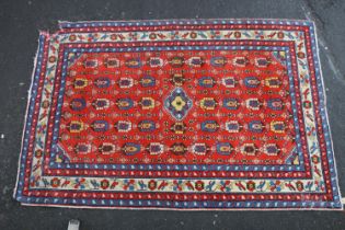 Persian Kilim style rug, repeating geometric motifs on a red background within cream border, 200cm x