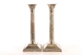 Pair of Victorian silver weighted candlesticks, modelled as Corinthian Columns on stepped bases,