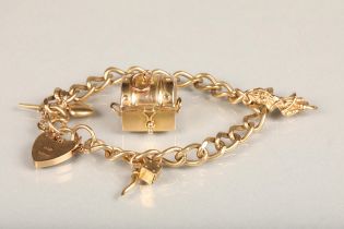9ct gold curb link charm bracelet with charms including treasure chest, dice, etc. with heart shaped
