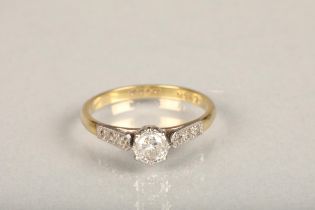 18ct yellow gold and platinum diamond solitaire ring, the diamond approximately 0.25cts flanked by