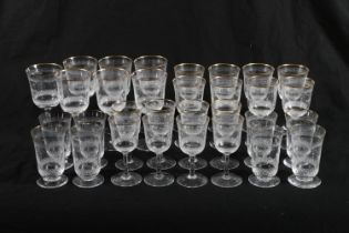 Partial suite of Stuart Crystal gilt edge drinking glasses with etched and cut detailing, comprising