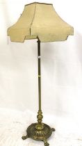 Early 20th century free standing brass floor lamp, the turned column on reeded oval base and four