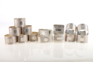 Set of ten George V silver napkin rings, the round bodies with engine-turned decoration and square