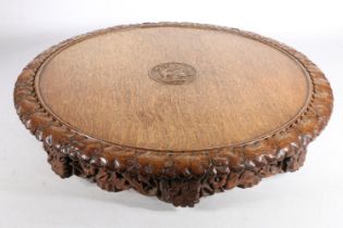 Victorian carved oak revolving Lazy Susan, the plain top with central Welsh dragon, acorn and oak