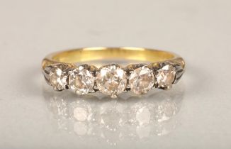 18ct gold and five stone diamond ring, the graduating diamonds set on a white gold scrolled mount