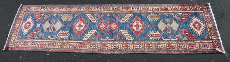 Caucasian style runner, the geometric designs on a blue ground within conforming polychrome