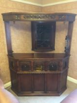 20th century carved oak corner bar unit with five panel front, the lower frieze with bullseye and