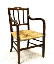 Early 20th century arts and crafts style armchair, the curved back rail over square slat back,
