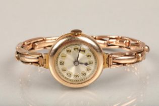 9ct gold cased ladies cocktail wristwatch, the round 9ct gold cased watch on 9ct gold extender