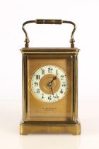 Early 20th century brass carriage clock timepiece, the cream porcelain chapter ring dial with Arabic