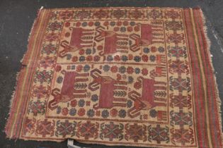 Caucasian carpet rug, the beige ground decorated with geometric goats and flowers within a geometric