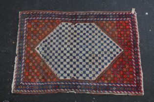 Kilim style rug, the cream background lozenge shaped field bordered by a conforming red ground