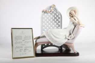 Lladro figure 'Garden of Dreams', of a woman with wide brimmed hat reclining in front of floral