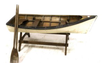 Large carved model of a row boat or dinghy, mid 20th century, the boat with fitted plank seats and