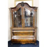 Dutch walnut bombe display cabinet, 19th century, the swan neck pediment with central belted