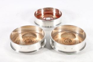 Pair of ERII silver wine coasters with one similar matched silver coaster etched to rim with Lion