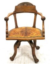 Early 20th century oak swivel desk chair, the shaped top rail with sunburst carved decoration,