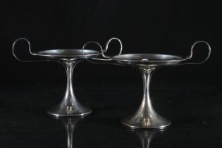 Pair of Edward VII Art Nouveau two handled silver pedestal dishes, the flat round body with C scroll