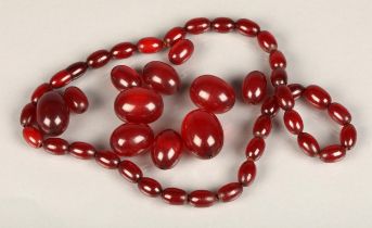 Early to mid 20thC cherry amber or Bakelite beaded necklace with larger loose beads, max bead size