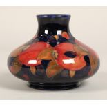 Moorcroft pottery vase, of squat form, blue ground in the pomegranate pattern, impressed mark with