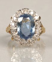 Ladies blue topaz and diamond ring, Central stone surrounded by fourteen brilliant cut 0.1 carat